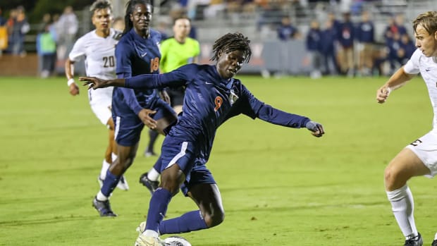 Stephen Annor dribbles the ball during the Virginia men's soccer game against ETSU at Klockner Stadium.